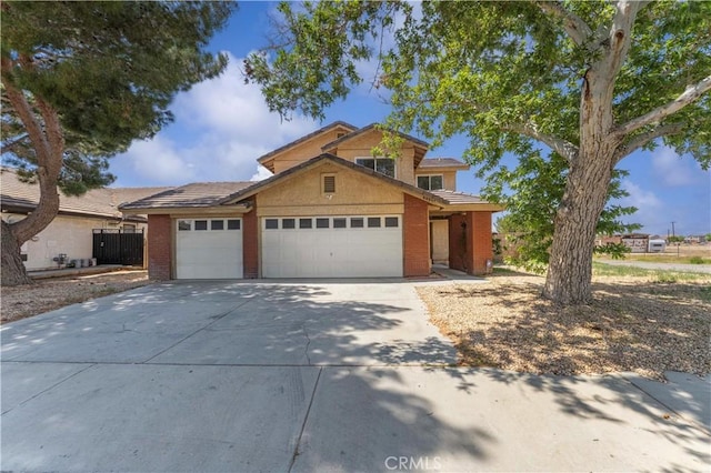 traditional home with concrete driveway, brick siding, and a garage