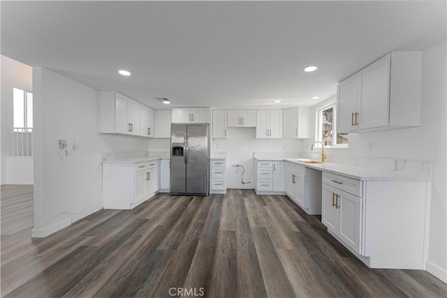 kitchen featuring white cabinets, dark wood-style flooring, a sink, and stainless steel fridge with ice dispenser