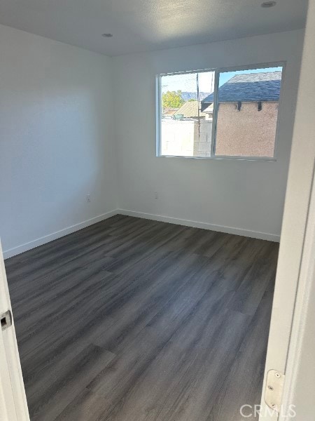 12929 Van Nuys Blvd, Pacoima, CA 91331 - empty room with dark wood finished floors and baseboards