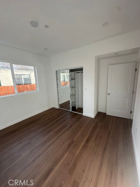 12929 Van Nuys Blvd, Pacoima, CA 91331 - unfurnished bedroom with a closet, baseboards, and dark wood finished floors