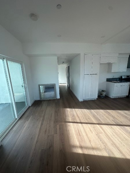 12929 Van Nuys Blvd, Pacoima, CA 91331 - unfurnished living room featuring dark wood-style floors