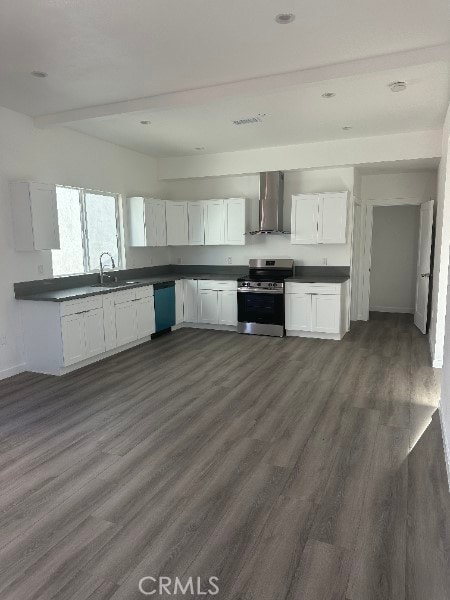 12929 Van Nuys Blvd, Pacoima, CA 91331 - kitchen with dark countertops, wall chimney exhaust hood, stainless steel range with electric stovetop, and dishwasher