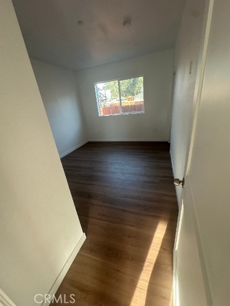 12929 Van Nuys Blvd, Pacoima, CA 91331 - empty room with baseboards and dark wood-style flooring