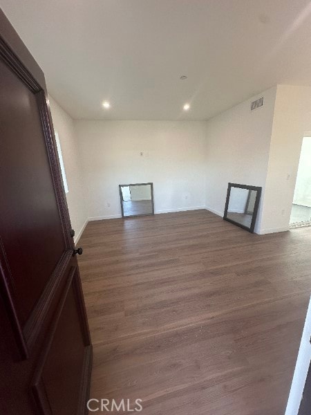 12929 Van Nuys Blvd, Pacoima, CA 91331 - empty room with baseboards, dark wood-style flooring, visible vents, and recessed lighting
