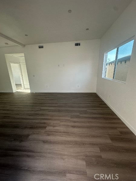 12929 Van Nuys Blvd, Pacoima, CA 91331 - empty room featuring dark wood-style floors, baseboards, and visible vents