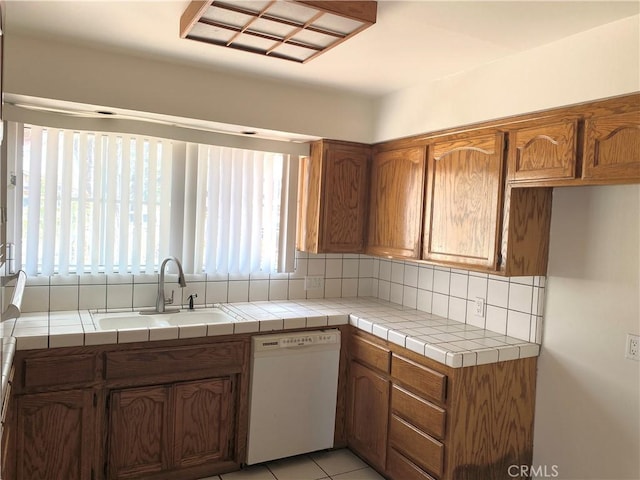 3816 Phaffle Dr, Bakersfield, CA 93309 - kitchen with white dishwasher, tasteful backsplash, and brown cabinets