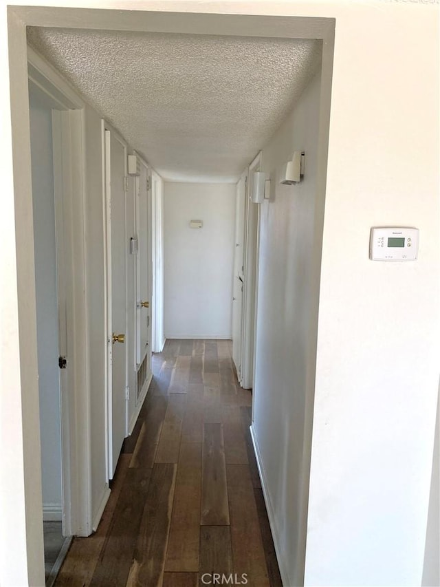 3816 Phaffle Dr, Bakersfield, CA 93309 - hall with dark wood-style flooring and a textured ceiling
