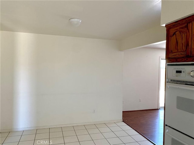 3816 Phaffle Dr, Bakersfield, CA 93309 - kitchen with white oven, wall oven, and light tile patterned floors