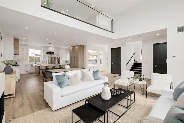 201 S Juanita Ave, Redondo Beach, CA 90277 - living area with recessed lighting, stairs, light wood finished floors, and a high ceiling
