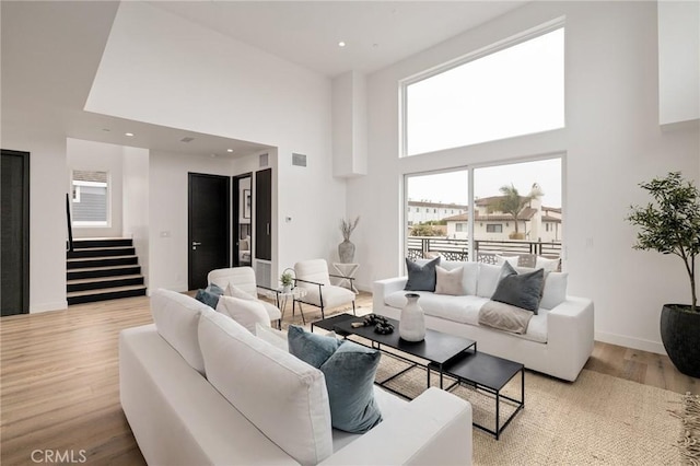 201 S Juanita Ave, Redondo Beach, CA 90277 - living area with a towering ceiling, stairway, light wood finished floors, and recessed lighting