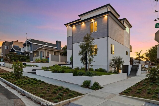 201 S Juanita Ave, Redondo Beach, CA 90277 - view of front of property featuring an attached garage, concrete driveway, stucco siding, and stairs