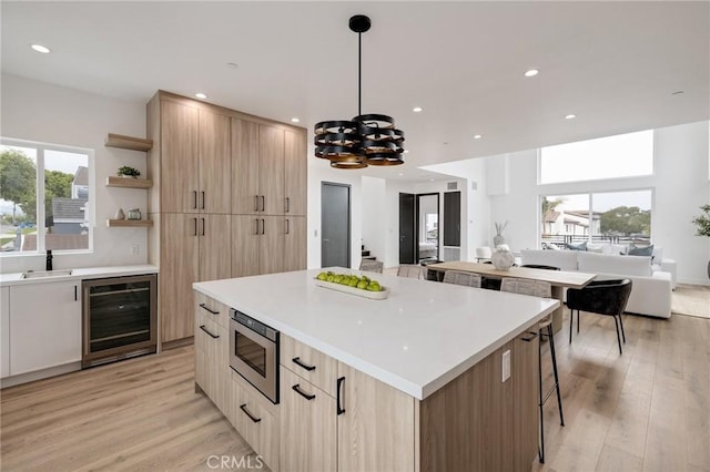201 S Juanita Ave, Redondo Beach, CA 90277 - kitchen with wine cooler, stainless steel microwave, light brown cabinetry, modern cabinets, and open shelves