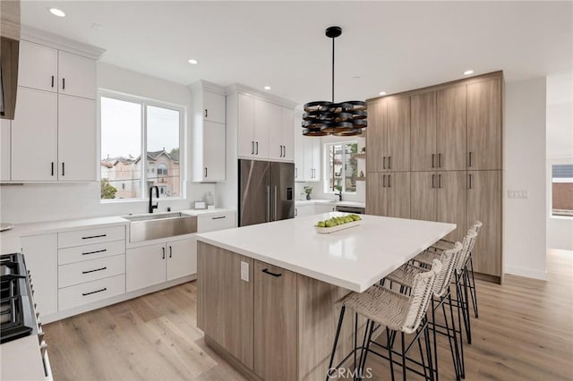201 S Juanita Ave, Redondo Beach, CA 90277 - kitchen featuring high quality fridge, a kitchen bar, a kitchen island, light wood-type flooring, and recessed lighting