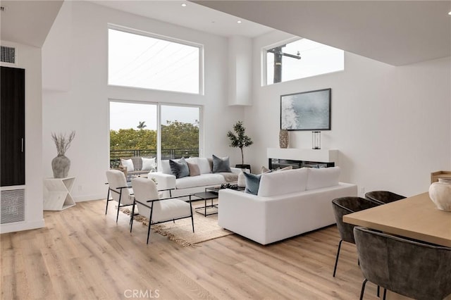 201 S Juanita Ave, Redondo Beach, CA 90277 - living area with a towering ceiling, healthy amount of natural light, light wood-style flooring, recessed lighting, and a heating unit
