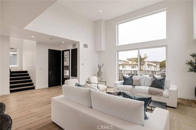 201 S Juanita Ave, Redondo Beach, CA 90277 - living room featuring stairs, a towering ceiling, healthy amount of natural light, wood finished floors, and recessed lighting