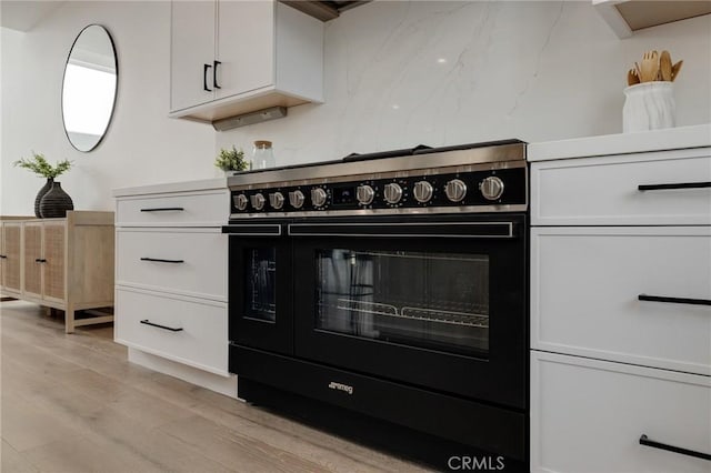 201 S Juanita Ave, Redondo Beach, CA 90277 - kitchen with range, light wood-style floors, and white cabinets