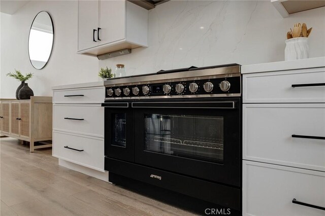 201 S Juanita Ave, Redondo Beach, CA 90277 - kitchen featuring high end stove, light wood finished floors, and white cabinets