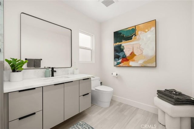 3876 Edgehill Dr, Los Angeles, CA 90008 - bathroom featuring baseboards, toilet, and vanity