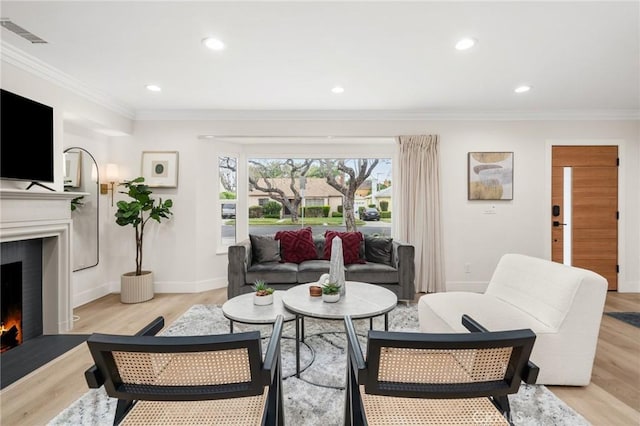 3876 Edgehill Dr, Los Angeles, CA 90008 - living room featuring a lit fireplace, crown molding, light wood-style flooring, recessed lighting, and baseboards