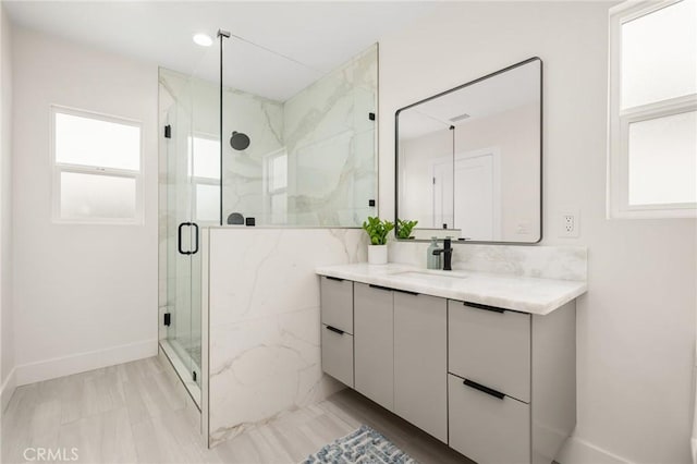 3876 Edgehill Dr, Los Angeles, CA 90008 - bathroom featuring vanity, a marble finish shower, and baseboards