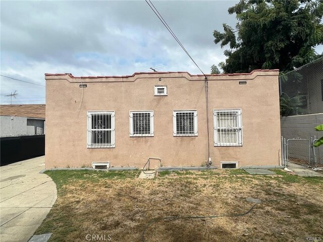 3030 W 12th Pl, Los Angeles, CA 90006 - view of property exterior with fence, a gate, and stucco siding