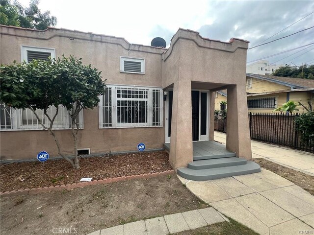 3030 W 12th Pl, Los Angeles, CA 90006 - mediterranean / spanish home featuring stucco siding and fence