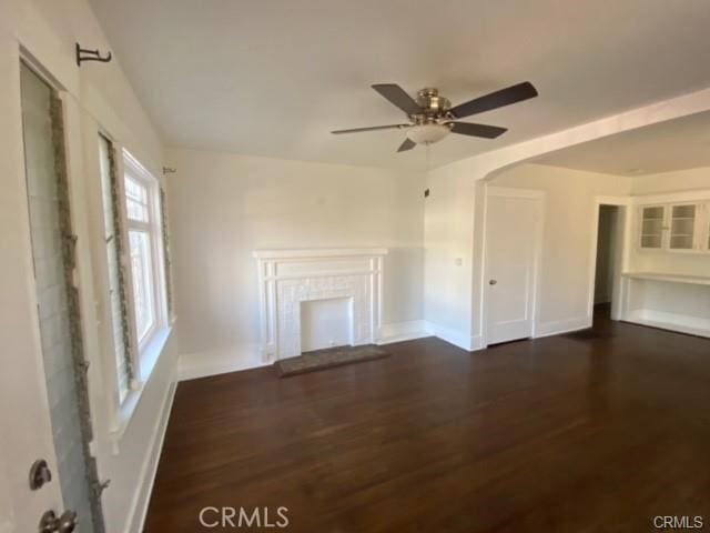 3030 W 12th Pl, Los Angeles, CA 90006 - unfurnished living room with baseboards, a ceiling fan, wood finished floors, and a fireplace