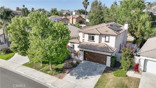 45924 Via Ln, Colorada, Temecula, CA 92592 - view of front facade with a tile roof, stucco siding, concrete driveway, a residential view, and roof mounted solar panels
