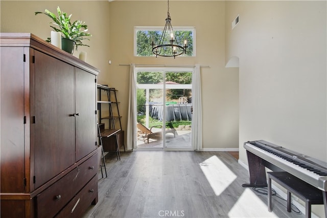 45924 Via Ln, Colorada, Temecula, CA 92592 - foyer featuring a chandelier, light wood-style flooring, a high ceiling, and baseboards