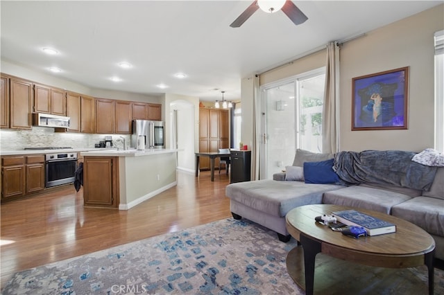 45924 Via Ln, Colorada, Temecula, CA 92592 - living area featuring light wood-style flooring, ceiling fan, a chandelier, recessed lighting, and baseboards