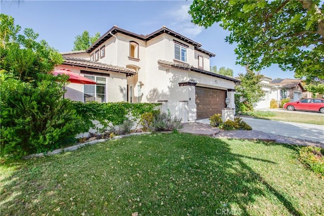45924 Via Ln, Colorada, Temecula, CA 92592 - mediterranean / spanish house with concrete driveway, a front yard, stucco siding, and an attached garage