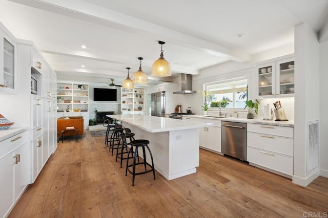 5171 College Gardens Ct, San Diego, CA 92115 - kitchen with appliances with stainless steel finishes, wall chimney exhaust hood, open floor plan, a kitchen breakfast bar, and beam ceiling