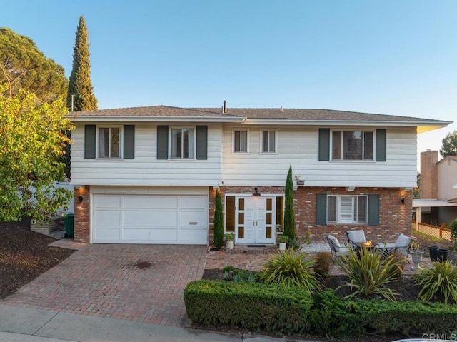 5171 College Gardens Ct, San Diego, CA 92115 - view of front of property featuring decorative driveway, an attached garage, and brick siding