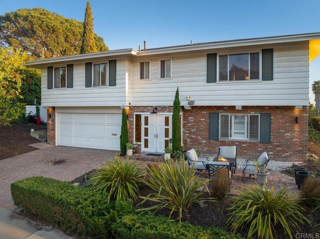 5171 College Gardens Ct, San Diego, CA 92115 - view of front of house featuring decorative driveway, brick siding, a garage, and french doors