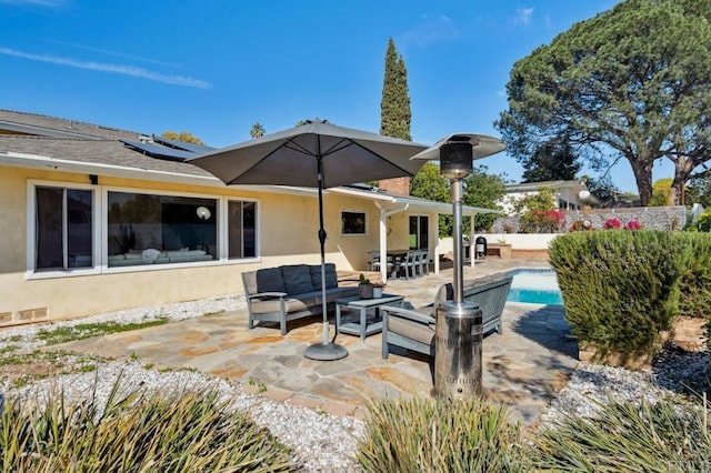 5171 College Gardens Ct, San Diego, CA 92115 - rear view of house featuring stucco siding, outdoor lounge area, roof mounted solar panels, a patio, and a fenced backyard
