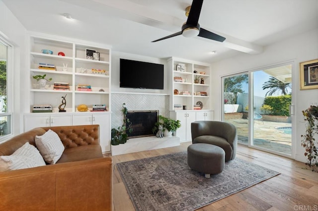 5171 College Gardens Ct, San Diego, CA 92115 - living room featuring wood finished floors, a tiled fireplace, ceiling fan, and beamed ceiling