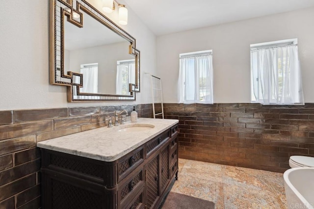 5171 College Gardens Ct, San Diego, CA 92115 - bathroom with tile walls, vanity, a freestanding tub, and wainscoting