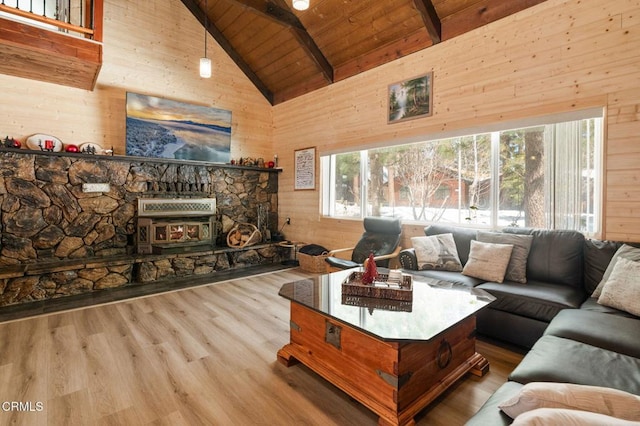 living area with wooden walls, beamed ceiling, wood ceiling, and high vaulted ceiling