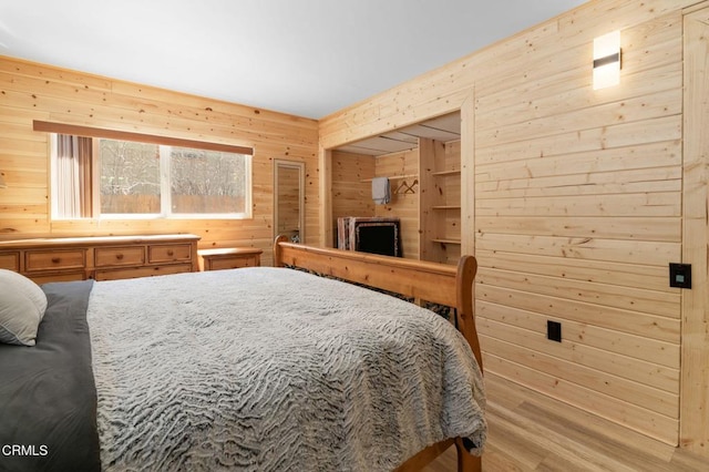 bedroom featuring wooden walls