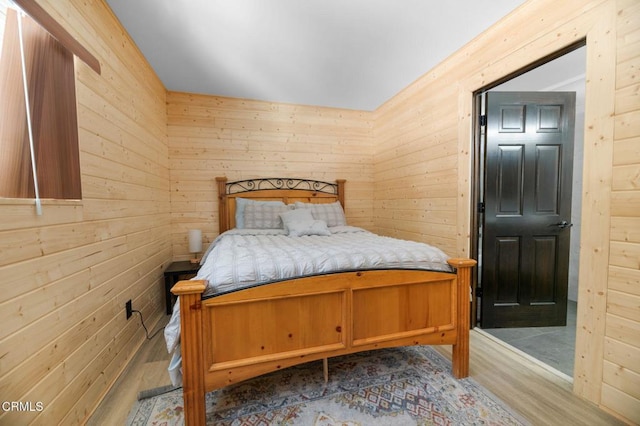 bedroom featuring wooden walls