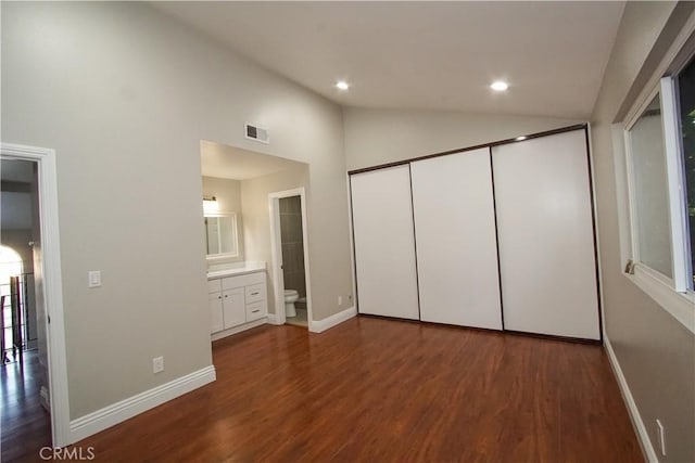 unfurnished bedroom with recessed lighting, dark wood-style flooring, baseboards, connected bathroom, and visible vents