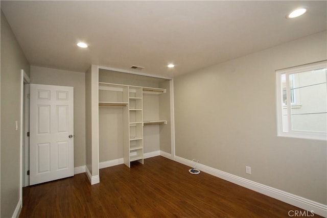 unfurnished bedroom with baseboards, dark wood-style flooring, and recessed lighting