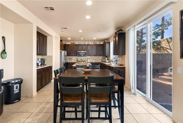 3070 Sand Pine Trl, Hemet, CA 92545 - dining area with light tile patterned floors, visible vents, and recessed lighting