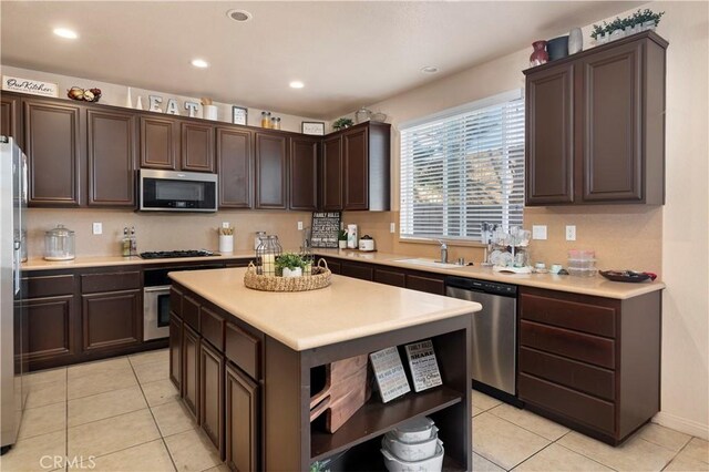 3070 Sand Pine Trl, Hemet, CA 92545 - kitchen with open shelves, a sink, stainless steel appliances, dark brown cabinetry, and light countertops