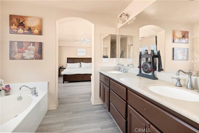 3070 Sand Pine Trl, Hemet, CA 92545 - bathroom with double vanity, connected bathroom, a garden tub, and a sink