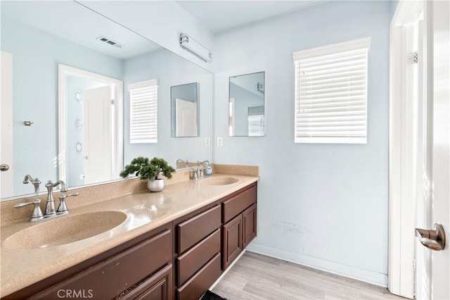 3070 Sand Pine Trl, Hemet, CA 92545 - full bath featuring a sink, visible vents, wood finished floors, and double vanity