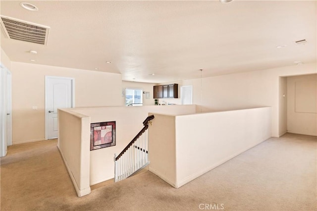 3070 Sand Pine Trl, Hemet, CA 92545 - hallway with baseboards, visible vents, an upstairs landing, and light carpet