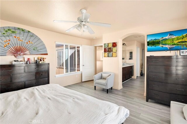 3070 Sand Pine Trl, Hemet, CA 92545 - bedroom with light wood-style floors, arched walkways, and ceiling fan