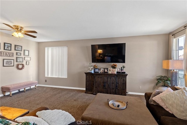 carpeted living area with baseboards and ceiling fan