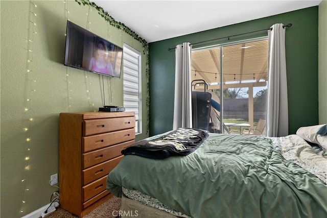 carpeted bedroom with access to outside